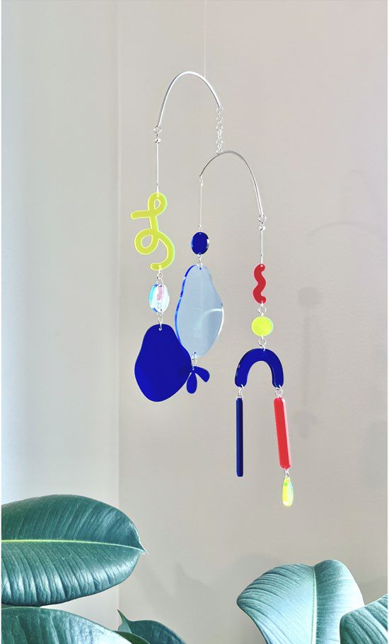 Finished acrylic suncatcher mobile hanging by a window